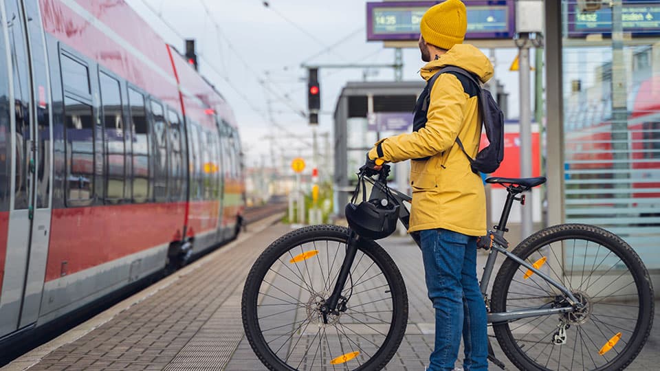 Man with bike getting on train